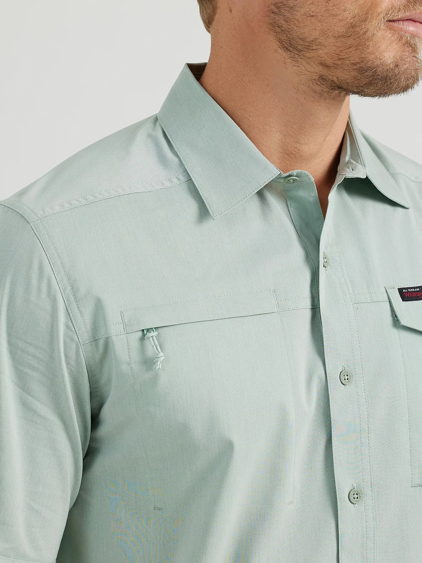 WRANGLER ATG MEN'S ASYMMETRICAL ZIP POCKET SHIRT IN GREEN BAY